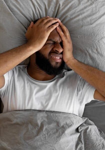 black man suffering from headache or migraine