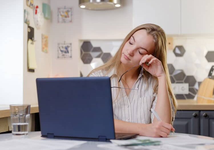 fatigued businesswoman taking off glasses head pain