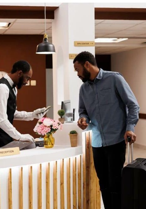 receptionist checking guest in hotel