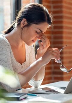 tired business woman with headache looking uncomfortable