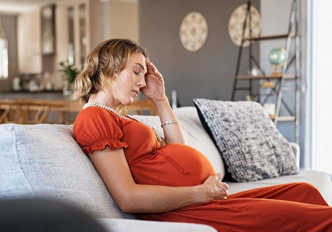 tired pregnant woman suffering headache tired pregnant woman suffering headache