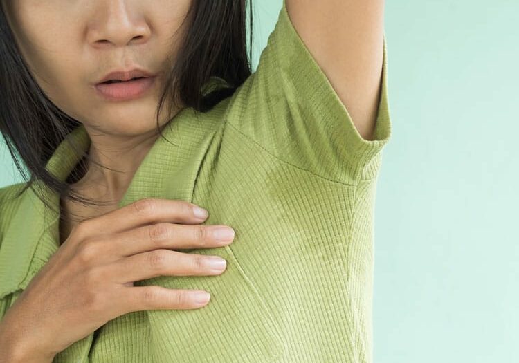 woman hyperhidrosis wet shirt underarm