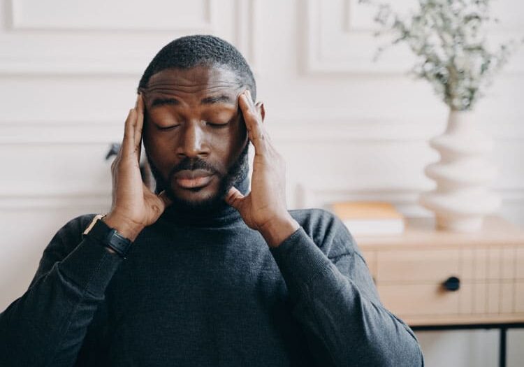 young african man with head pain