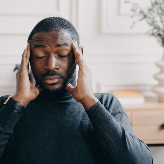 young african man with head pain